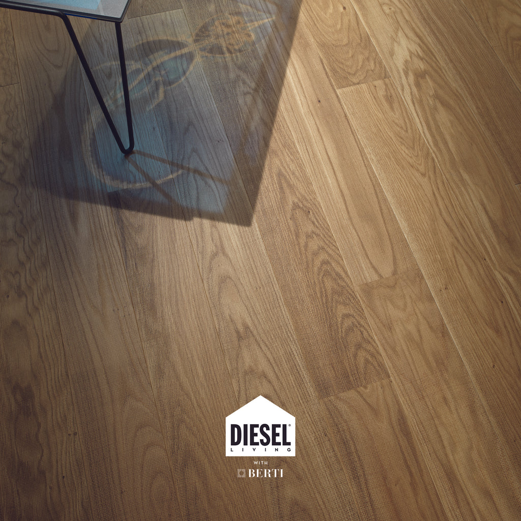 High-quality oak flooring from Diesel Living by Berti, featuring a textile-inspired texture and light tone.