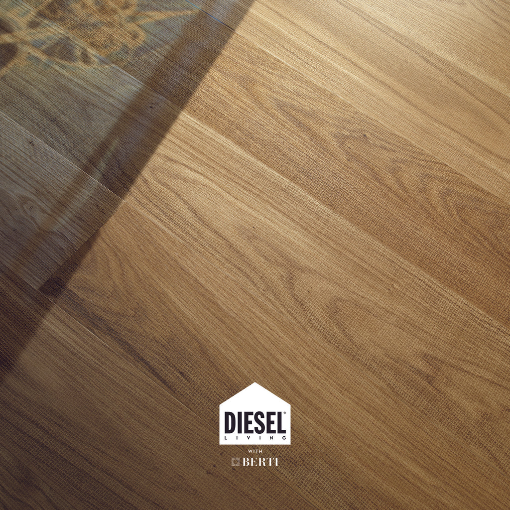 High-quality oak flooring from Diesel Living by Berti, featuring a textile-inspired texture and light tones.
