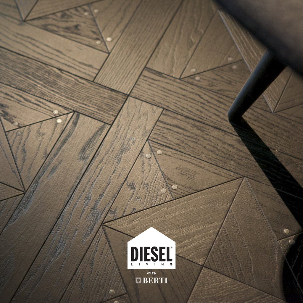 Stud Oak Dark Parquet flooring from Diesel Living and Berti, showcasing rich dark brown tones and stunning wood grain detail.